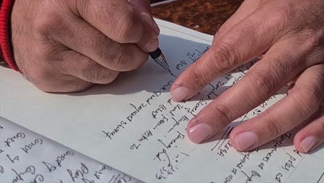 Hand-writes-on-notepad