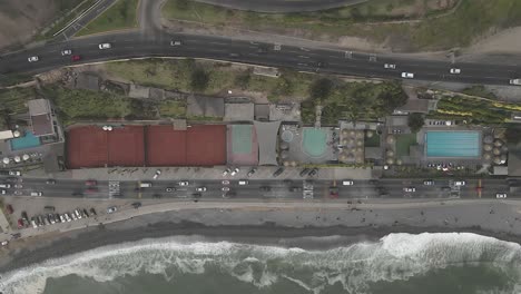 Top-down-aerial-view-of-coastal-highway-traffic-in-Miraflores,-Peru