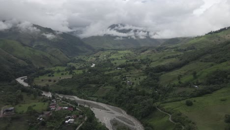 Low-aerial-flight-up-green-cloudy-Huancabamba-River-valley-in-Peru