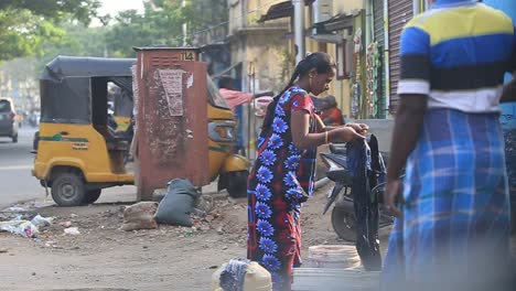 An-Indian-lady-washes-clothes-on-the-streets-of-Chennai,-India