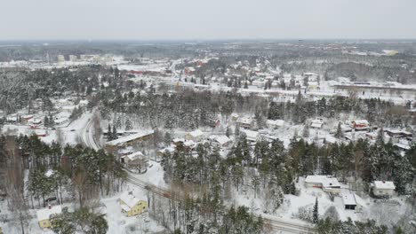 Aerial-forward-moving-view-over-residential-area-of-Ruohonpää-in-winter-time-after-snowfall-when-everything-is-covered-in-snow