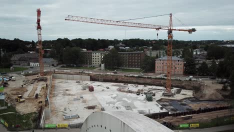 Drone-shot-of-construction-of-Tartu-university-Delta-Centre,-flight-over-the-bridge