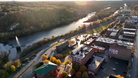High-aerial-drone-view-of-James-River-in-Lynchburg,-Virginia-during-autumn-sunrise