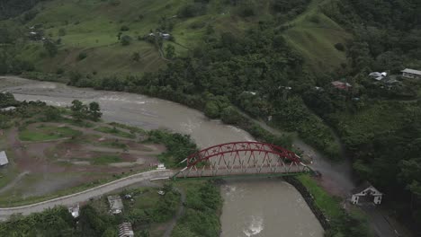 Aerial-tilt-to-bridge-near-Pozuzo-Arch-in-Huancabamba-Valley-of-Peru