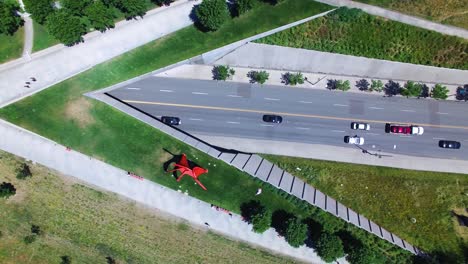Panning-aerial-of-Seattle's-Sculpture-Park-with-cars-driving-on-the-highway-underneat
