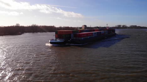 Aerial-Forward-Bow-View-Of-Millennium-Ship-And-Barge-Carrying-Cargo-Containers-Along-Oude-Maas