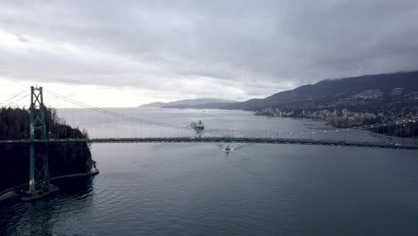 Ship-sailing-on-Burrard-Inlet-fjord-with-Lions-Gate-bridge-in-foreground