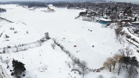 Many-people-ice-skating-in-the-nature-on-frozen-lake