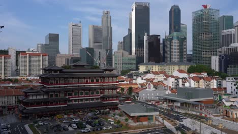 Buddha-tooth-relic-temple-against-Singapore-modern-skyline
