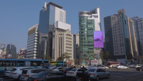 A-crowded-vehicular-intersection-near-Gangnam-Station-in-downtown-Seoul,-South-Korea