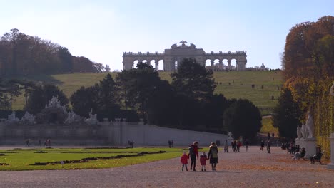 View-out-towards-famous-Gloriette-in-Schönbrunn-Vienna-with-people-walking