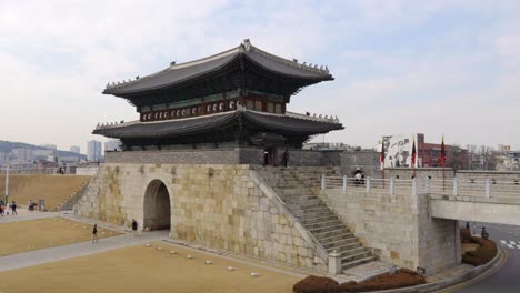 People-enter-Hwaseong-Fortress-through-Janganmun-North-Gate,-Suwon,-Korean-heritage