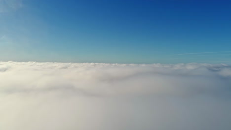 Drone-view-from-above-from-the-thick-white-clouds-at-sunrise