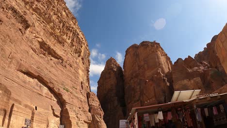 Watching-the-clouds-pass-above-the-tourists-and-ancient-tombs-of-Petra,-Jordan---time-lapse