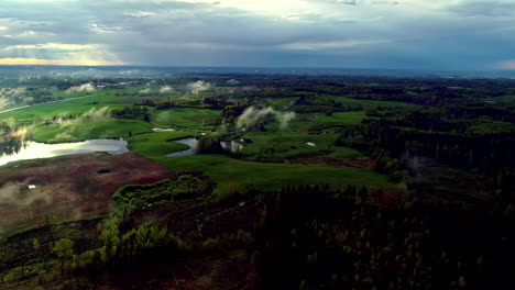 Aerial-View-Of-Green-Rural-Landscape-On-A-Cloudy-Sunset