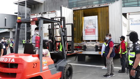 Covid-19-Vaccine-Arrival-An-The-Airport-In-The-Philipines,-The-Boxes-Containing-The-Vaccines-Are-Being-Moved-And-Placed-Inside-An-Insulated-Truck