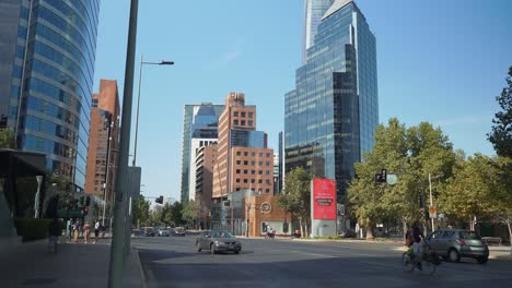 Incline-Hacia-Abajo-Los-Vehículos-De-Cercanías-En-Una-Avenida-Moderna-Con-Edificios-Lujosos-Durante-El-Día,-Santiago,-Chile
