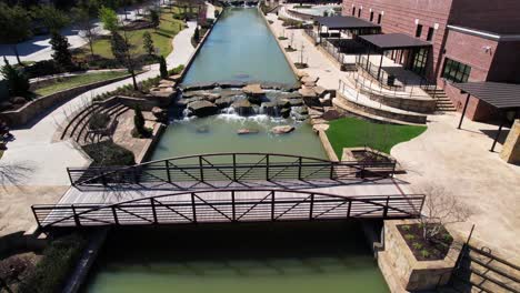 Aerial-footage-of-bridge-and-rocks-in-the-Riverwalk-in-Flowermound-Texas