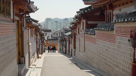 Bukchon-Hanok-Village-Is-the-name-traditional-cultural-village-in-downtown-Seoul,-people-take-picture-on-famous-street---walking-pov