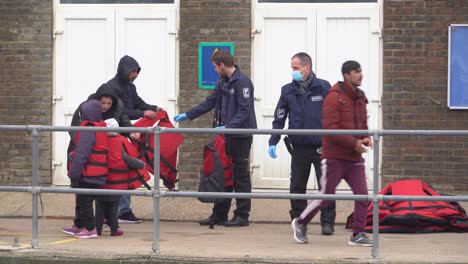 Refugee-children-and-their-family-take-off-life-jackets-in-Dover-after-illegally-crossing-the-English-Channel-from-France