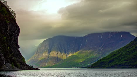 Grey-Clouds-flying-over-mountains-and-norwegian-Fjord---time-lapse-shot
