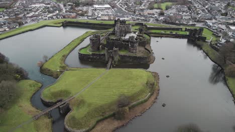 AERIAL:-Sideways-pan-shot-of-Castle,-Caerphilly,-4k-Drone