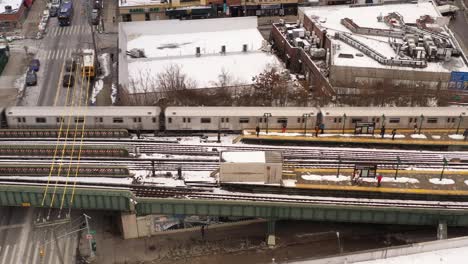 A-profile-view-a-subway-train-leaving-the-station-on-a-snowy-day
