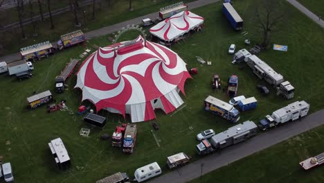 Planet-circus-daredevil-entertainment-colourful-swirl-tent-and-caravan-trailer-ring-aerial-view-high-orbiting-right