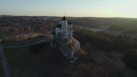 Aerial-drone-view-of-Bobolice-Royal-Castle-at-sunset,-Poland