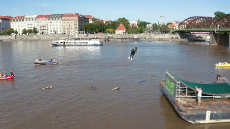 Tracking-a-Freeski-athlete-as-they-perform-freestyle-acrobatics-on-the-Vltava-river,-Prague,-aerial
