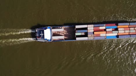 Aerial-Birds-Eye-View-Of-Missouri-Ship-Carrying-Shipping-Containers-Along-River-Noord-Going-Past