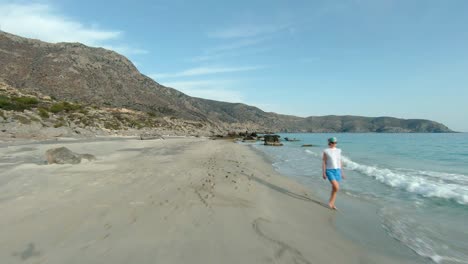 Woman-walking-along-the-beach,-Kedrodasos-Greece