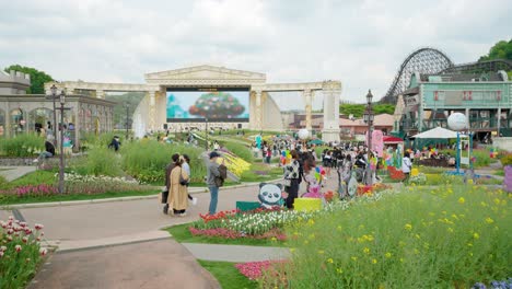 People-wearing-face-masks-enjoy-the-gardens-and-rides-at-Everland-Amusement-Park-in-Yongin,-South-Korea