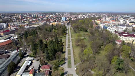 Walking-and-resting-people-in-the-park-in-the-middle-of-the-city-of-Olomouc-on-a-sunny-spring-day,-Czech-Republic