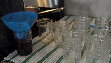 Filling-jars-of-homemade-berry-jam-for-sealing---slow-motion
