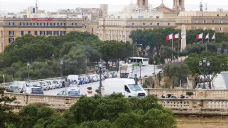 Malta-street-with-driving-vehicles-and-landmark-architecture-in-background