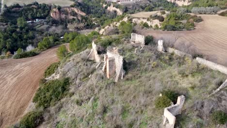 Aerial-360-Around-Ruin-Of-Farmhouse-On-Hillside-In-Catalonia-Landscape