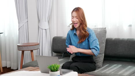 Smiling-young-businesswoman-using-laptop-sitting-at-home-office-desk,-happy-female-customer-make-distant-online-work