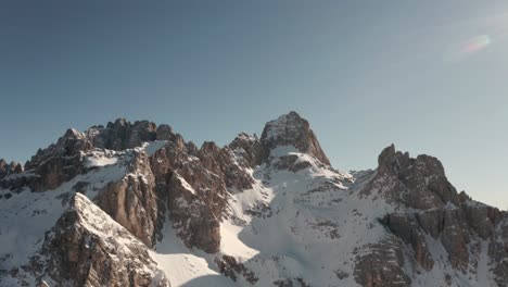 Rising-circling-drone-shot-over-jagged-snowy-peaks