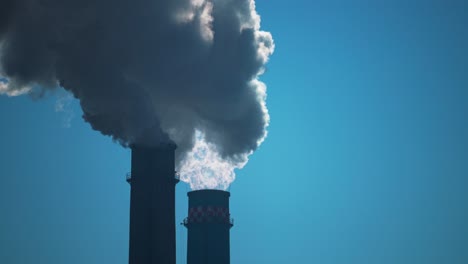 Tall-smoking-industrial-chimnies,-emissions-of-greenhouse-gases-into-the-atmosphere-global-warming