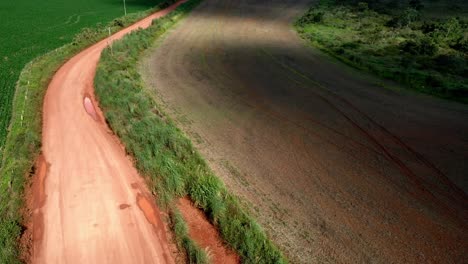 Ascending-over-a-red-dirt-road-to-see-deforested-land-in-the-Brazilian-savannah-to-plant-soybeans