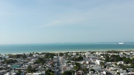 Tilt-up-aerial-view-over-Puerto-Progreso-city-in-Yucatan-peninsula,-Mexico