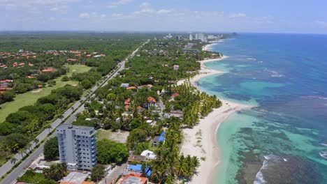 Aerial-flyover-luxury-city-with-hotel-tower,private-beach-and-coral-reef-in-caribbean-sea-during-summer