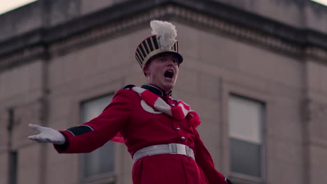 SLOW-MOTION---Man-in-marching-band-suit-and-white-gloves-shouts-in-Christmas-Parade