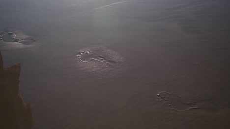 Female-Feet-Leaving-Footprints-In-Sand,-Walking-On-Beach---close-up