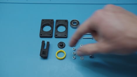 Picking-Parts-Prepared-For-Assembly-on-Blue-Table