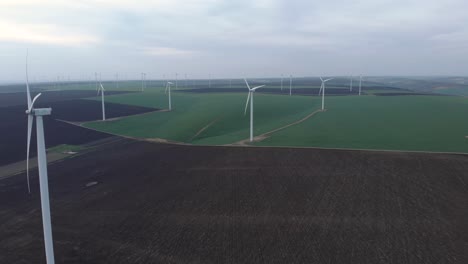 Large-Wind-Turbines-with-Rotating-Blades-in-Field,-Aerial-View