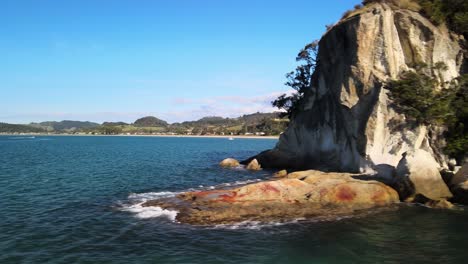 Revealing-from-behind-limestone-cliffs-to-a-bay-in-the-Coromandel-Peninsula