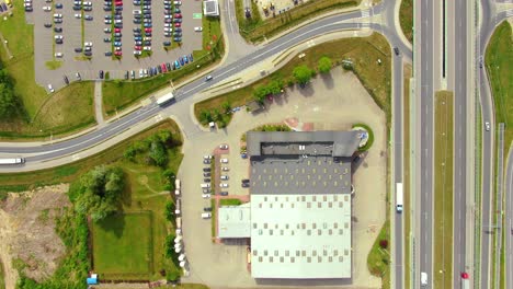 Aerial-top-down-view-of-the-big-logistics-park-with-warehouses,-loading-hub-and-a-lot-of-semi-trucks-with-cargo-trailers-awaiting-for-loading-unloading-goods-on-ramps