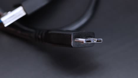 Hard-disk-ssd-wire-plug-connector,-black-background-macro-shot-close-up-view-in-4k-rotating-motion